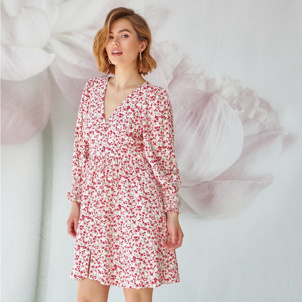 Summer knee-length dress with a small red floral print.